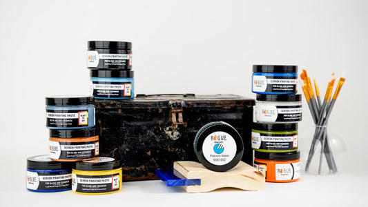 Styled product photography featuring Rogue screen printing paste jars arranged with a vintage toolbox, paint brushes, and glass pieces for small business branding