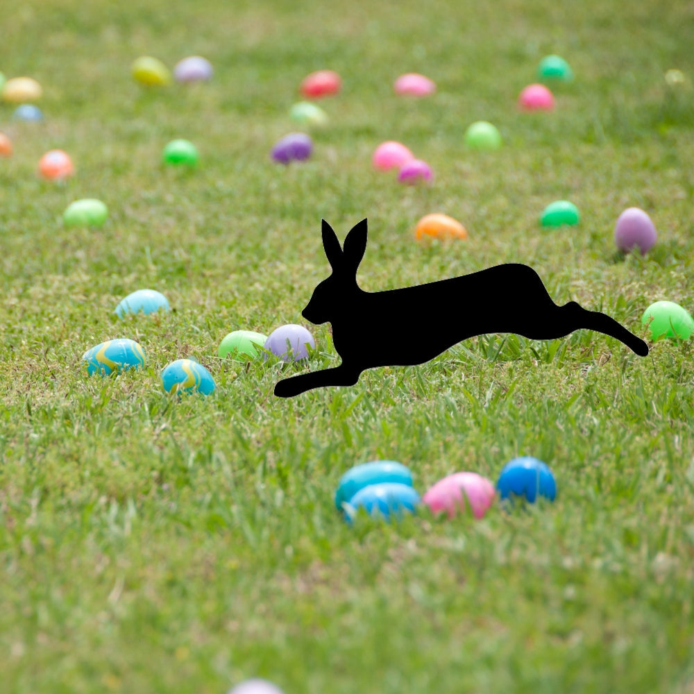 Precut glass shape of a rabbit sprinting in a field of eggs.