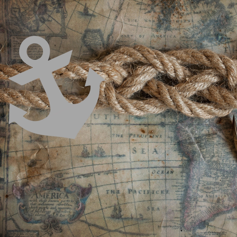 Precut glass shape of an anchor on a map.