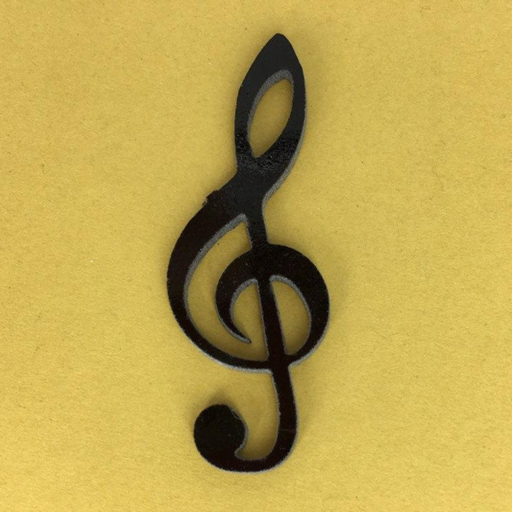 Precut glass shape of a treble clef in black glass.