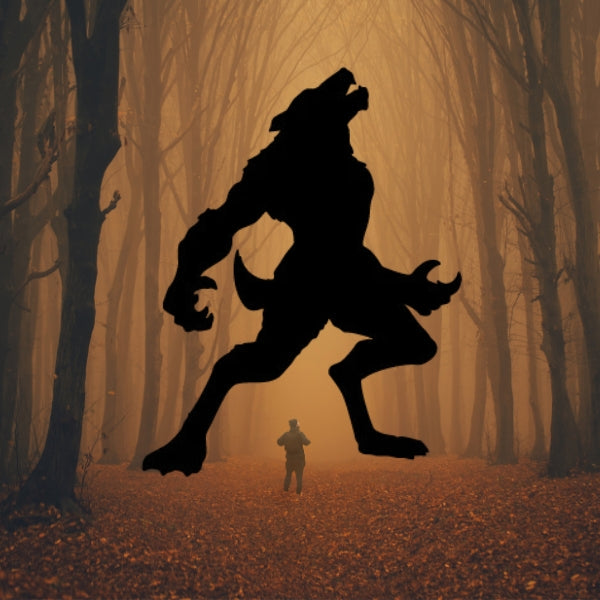 Bullseye COE 90 Glass Precut silhouette of a large werewolf howling in a misty, orange-tinted forest while a person stands in the distance on a leaf-covered path."