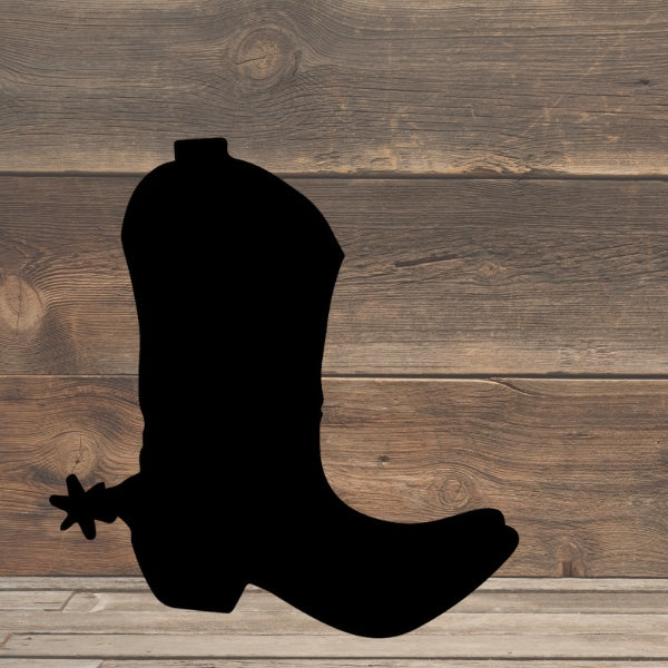 Oceanside COE 96 Glass silhouette of a cowboy boot with a spur, centered against a backdrop of a wooden wall and floor, evoking a western or country-style aesthetic.